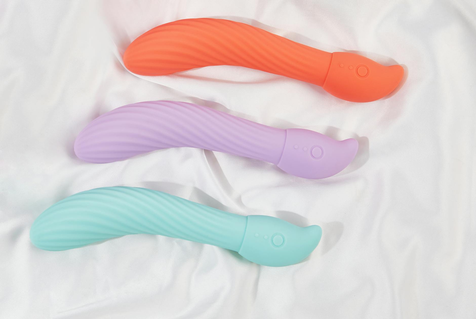Woman holding a blue vibrator, representing vulnerability and openness in intimate partnerships.