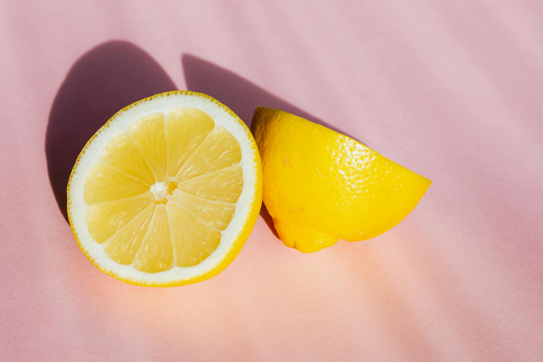 Fresh lemon halves on a pink surface, symbolizing renewal and fresh approaches to intimacy