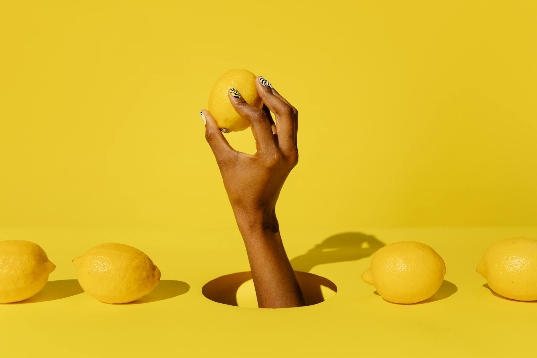 Yellow silicone vibrator surrounded by fresh bananas on a bright yellow background
