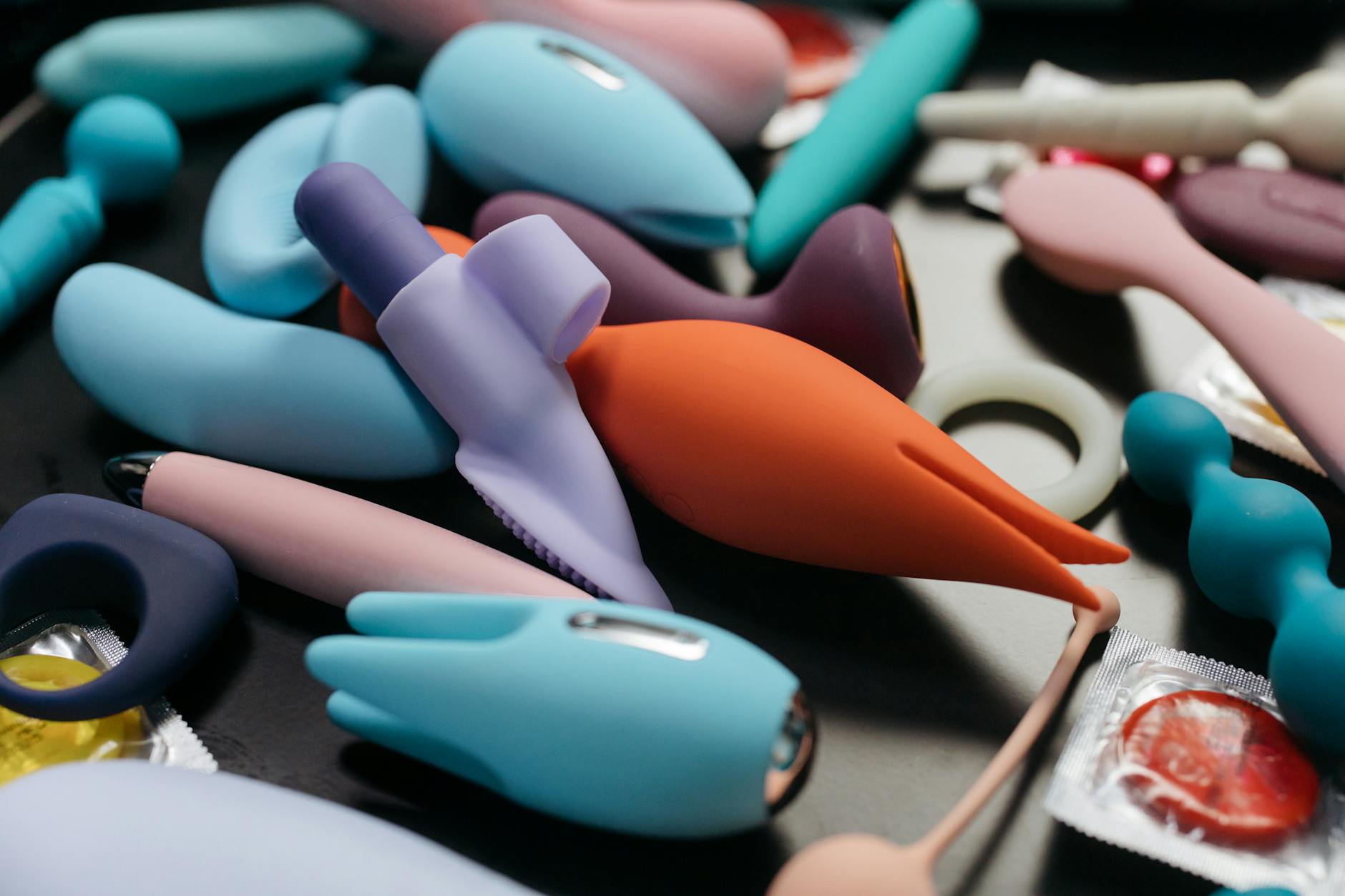 Close-up view of colorful vibrators and adult wellness toys arranged together