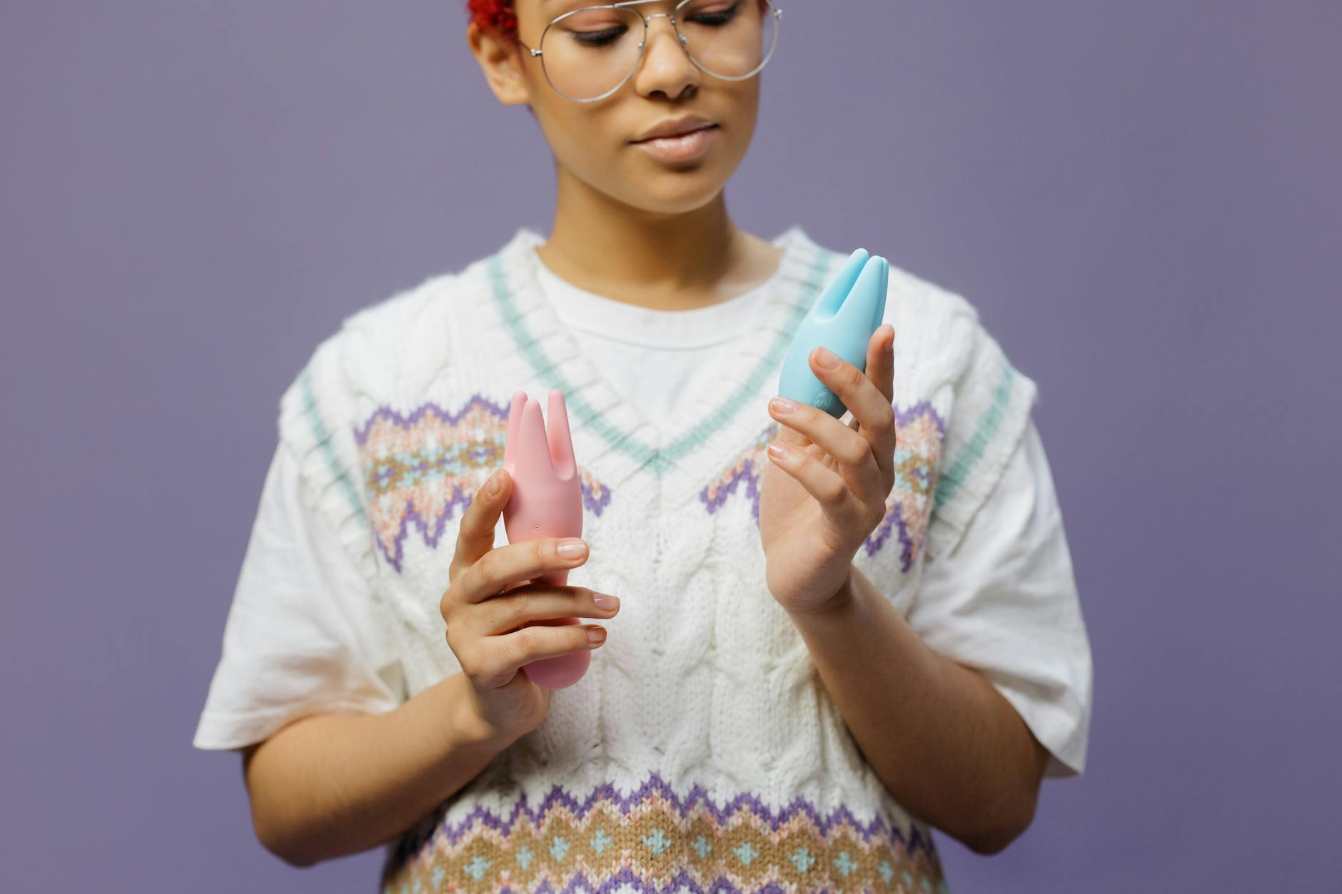 Person holding a lemon clitoral vibrator and considering pleasure with medication.