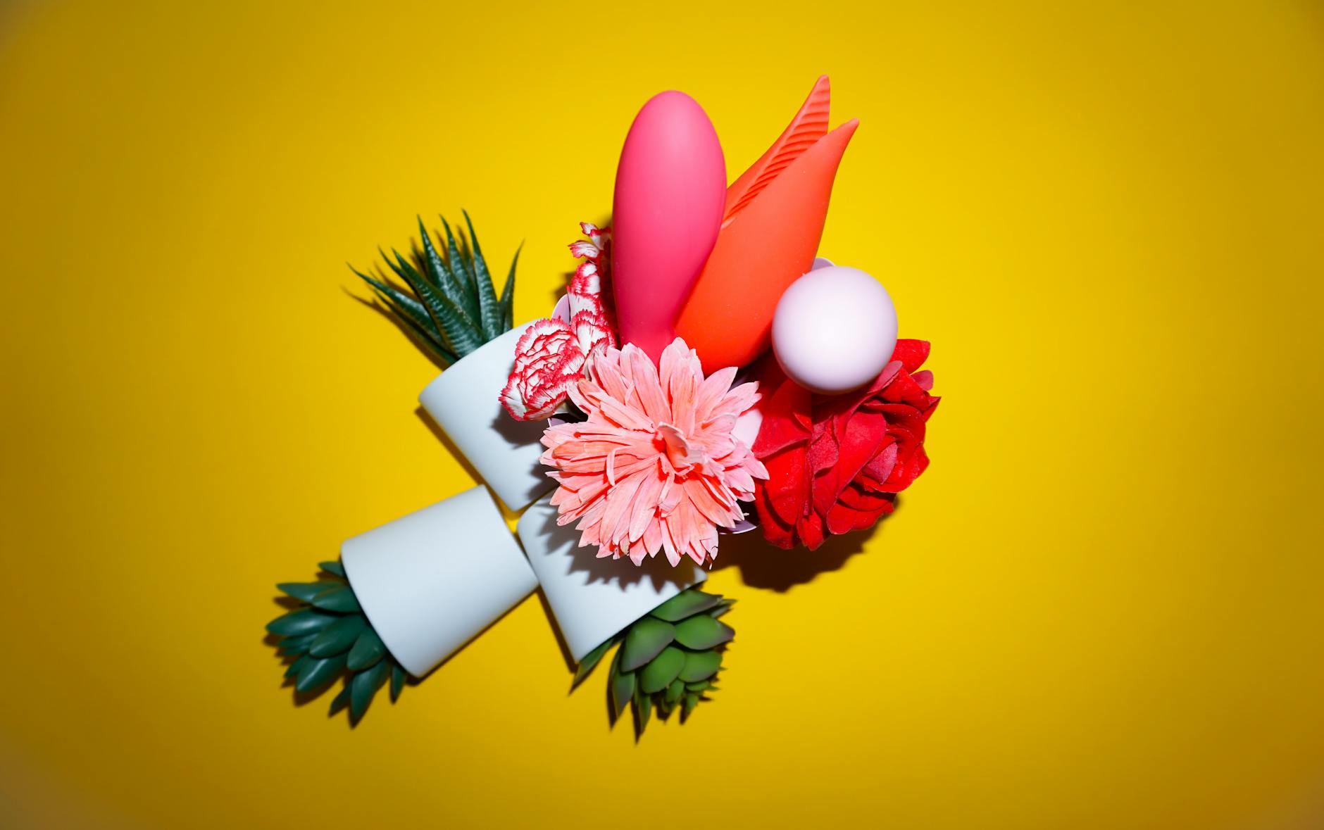 Hands holding colorful silicone vibrators for solo pleasure and self-discovery